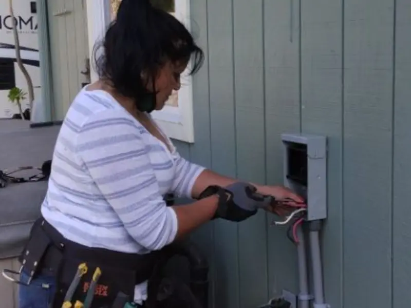 Licensed electrician wiring an exterior subpanel in West Salem