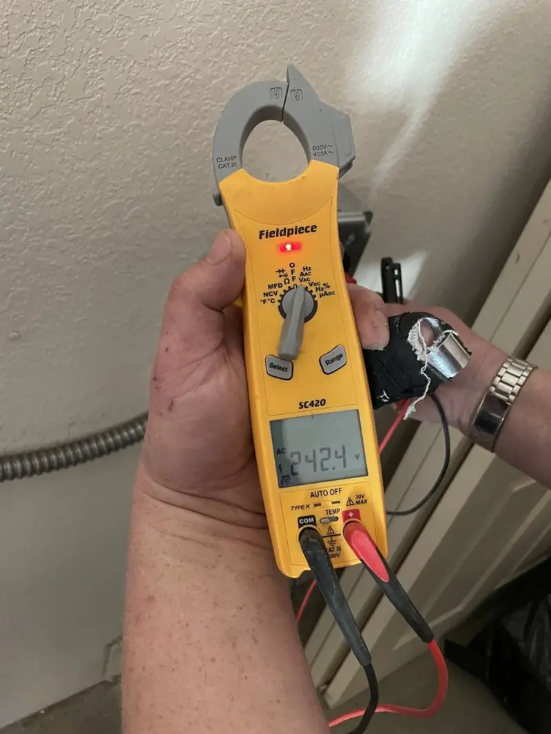 Voltage testing with clamp meter during Whole House Surge Protector in West Salem